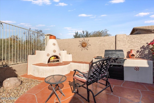 view of patio featuring exterior fireplace