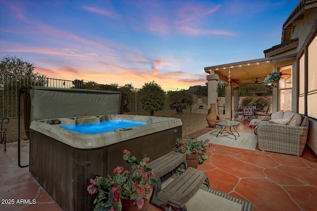 patio terrace at dusk with a hot tub