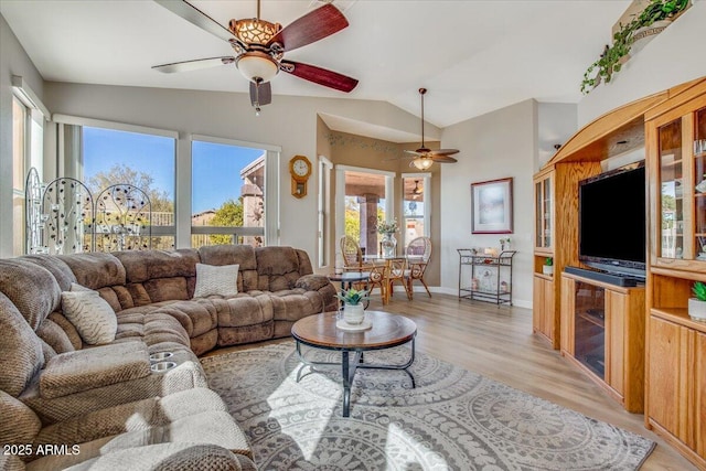 living room featuring ceiling fan, vaulted ceiling, and light hardwood / wood-style floors