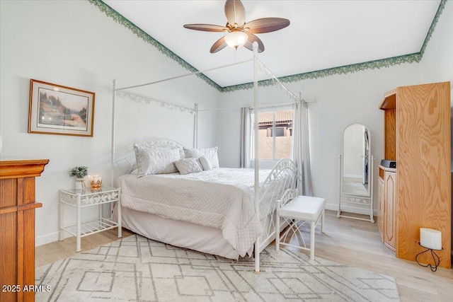 bedroom with ceiling fan and light hardwood / wood-style flooring