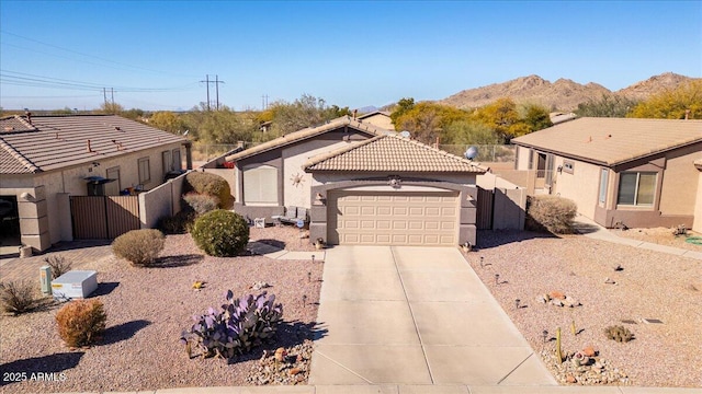 view of front of property with a garage and a mountain view