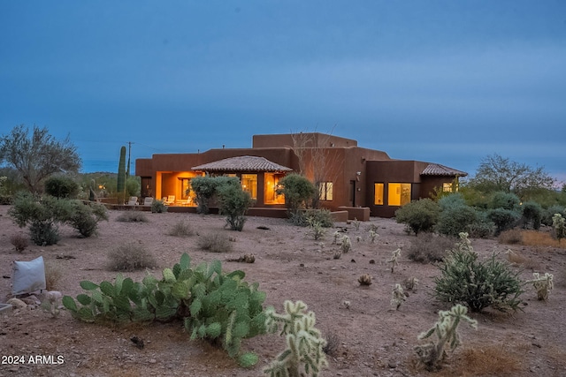 view of back of property at dusk