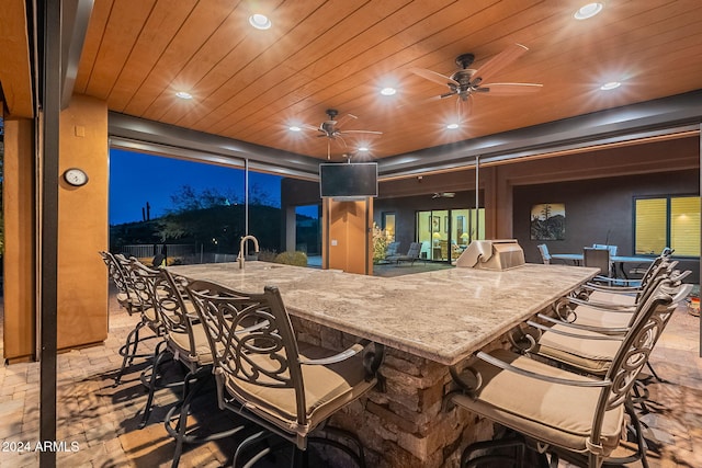 view of patio / terrace featuring outdoor wet bar and a ceiling fan