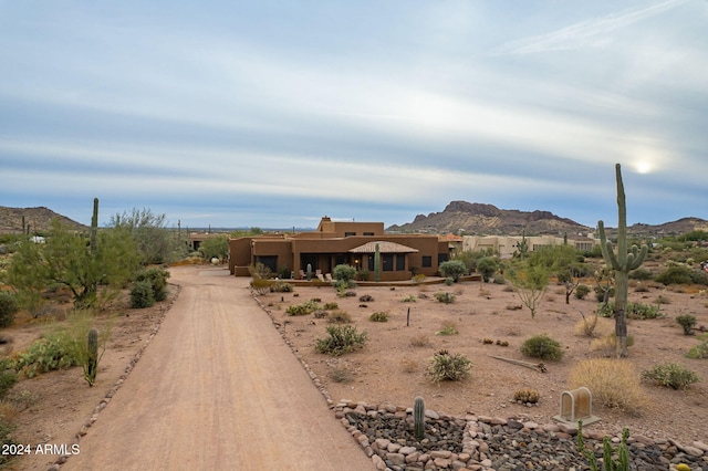 exterior space featuring a mountain view and stucco siding