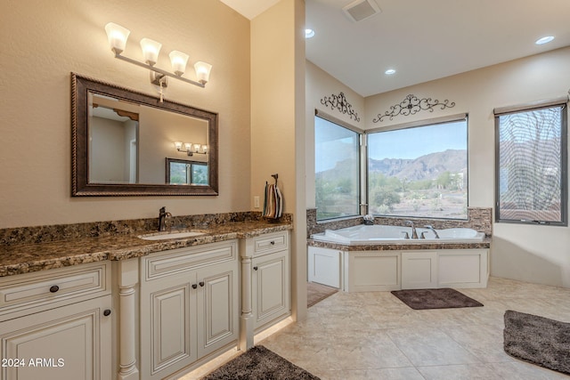 bathroom with recessed lighting, visible vents, a mountain view, vanity, and a bath