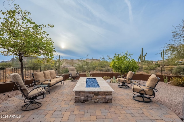 view of patio / terrace with an outdoor living space with a fire pit and a fenced backyard