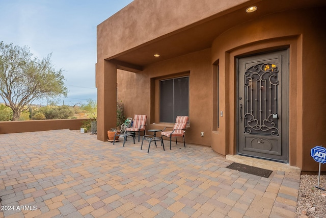 doorway to property with a patio area and stucco siding