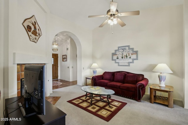 carpeted living room with ceiling fan