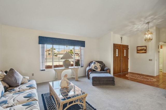 living room with carpet, lofted ceiling, and an inviting chandelier