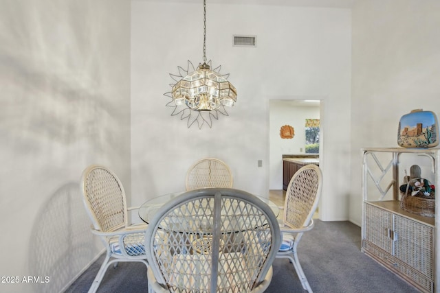 carpeted dining room featuring an inviting chandelier