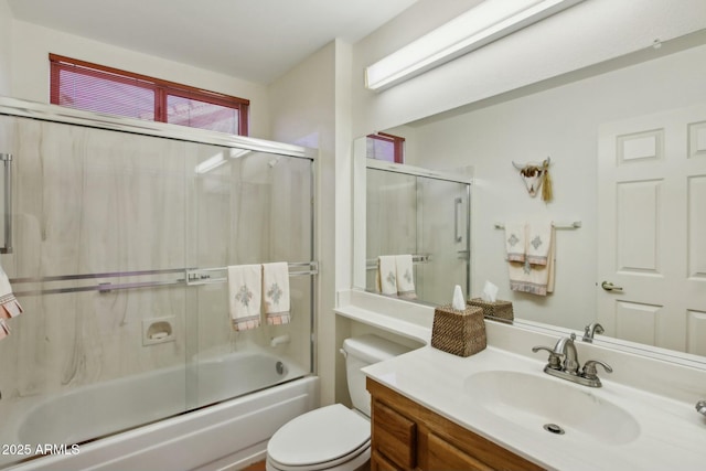 full bathroom featuring enclosed tub / shower combo, vanity, and toilet