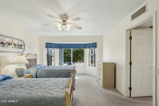 bedroom with ceiling fan and light carpet