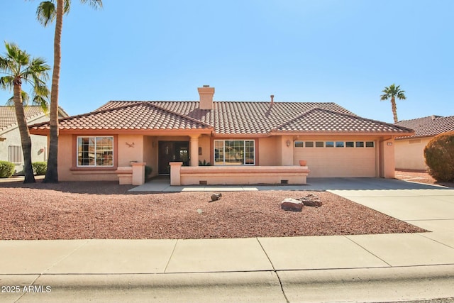 mediterranean / spanish house featuring a garage