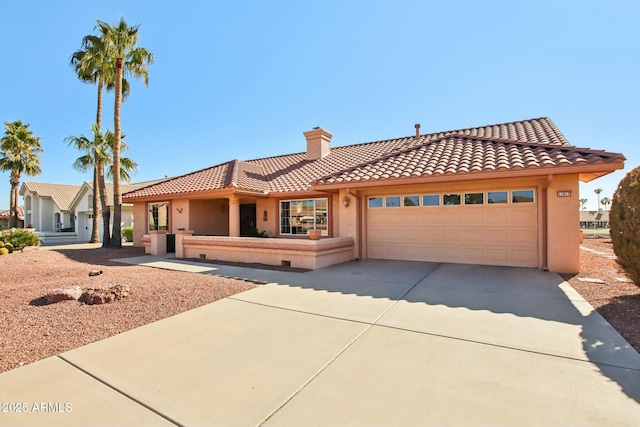 mediterranean / spanish-style home with a garage