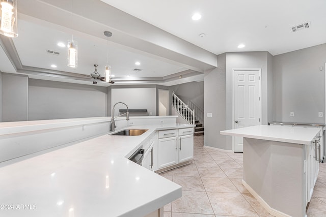 kitchen featuring white cabinetry, a kitchen island, sink, hanging light fixtures, and light tile patterned flooring