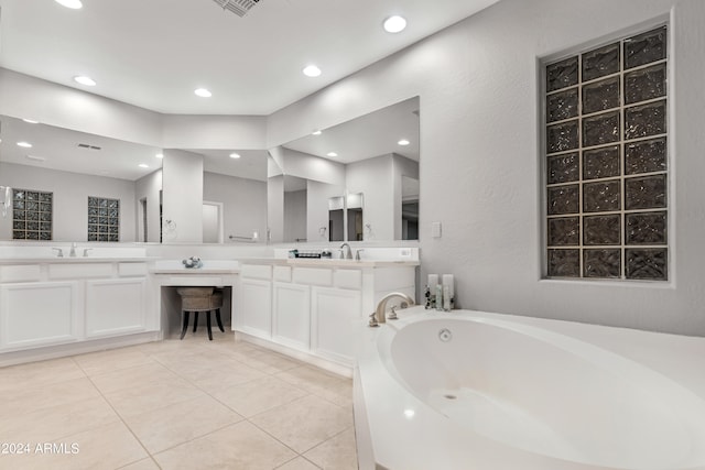 bathroom featuring tile patterned flooring, a washtub, and vanity