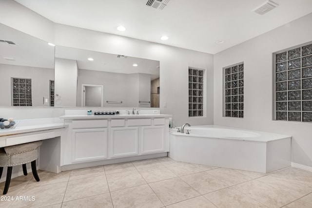 bathroom featuring vanity, a bathing tub, and tile patterned floors