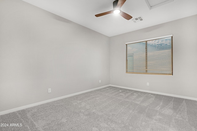 carpeted spare room with ceiling fan