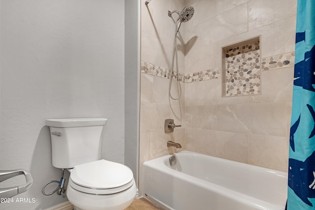 bathroom with toilet and shower / tub combo with curtain