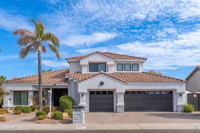 mediterranean / spanish-style house with a garage