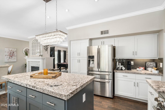 kitchen with white cabinets, stainless steel fridge with ice dispenser, and a center island