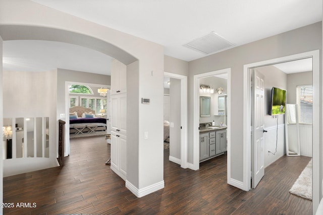 hallway with dark hardwood / wood-style floors and sink