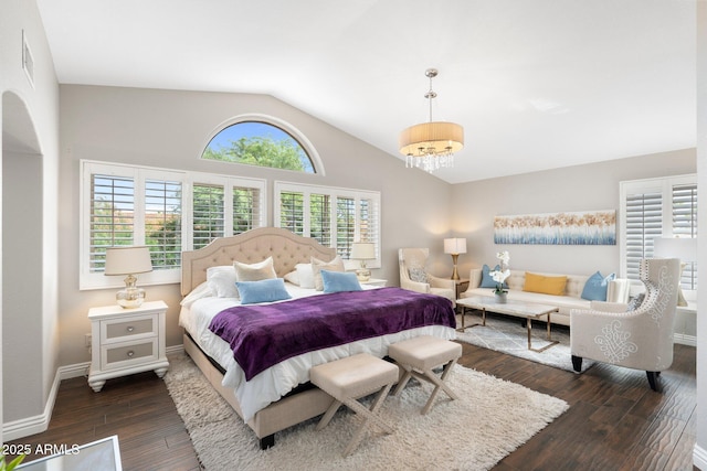 bedroom with lofted ceiling and dark hardwood / wood-style floors