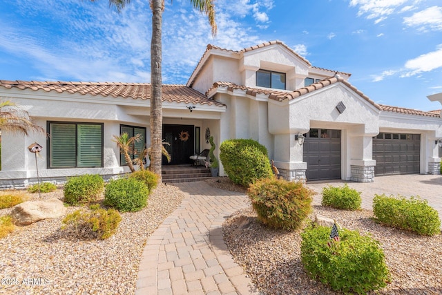 mediterranean / spanish house featuring a garage