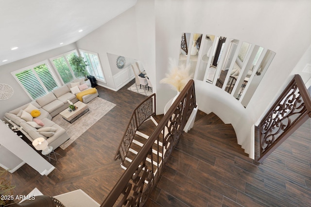 living room featuring high vaulted ceiling and dark hardwood / wood-style floors