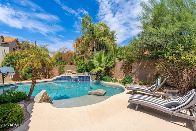 view of pool featuring a patio and an in ground hot tub