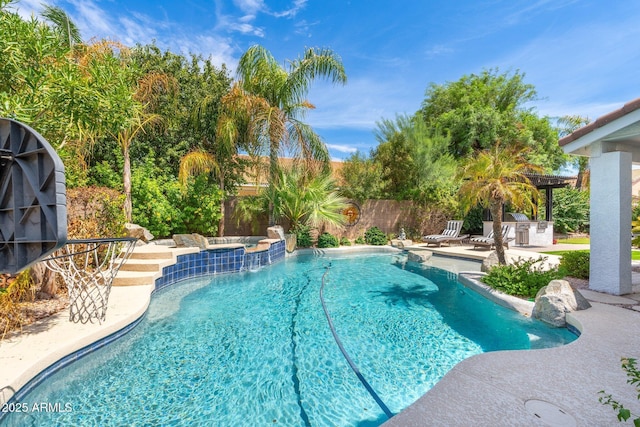 view of swimming pool with an in ground hot tub, a patio area, and area for grilling