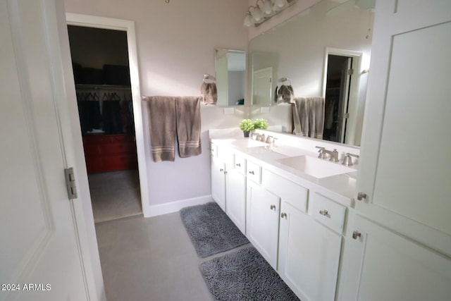 bathroom with vanity and concrete flooring