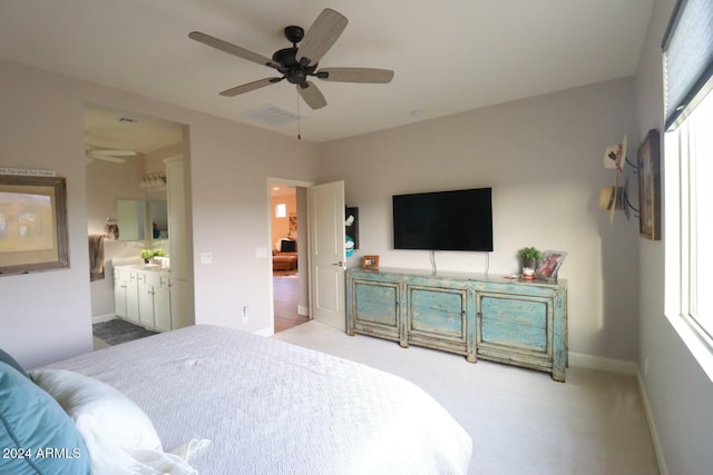 bedroom with carpet, ensuite bath, and ceiling fan