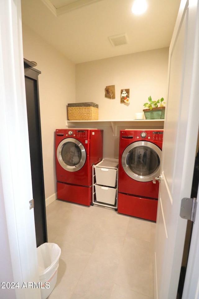 clothes washing area with washing machine and dryer