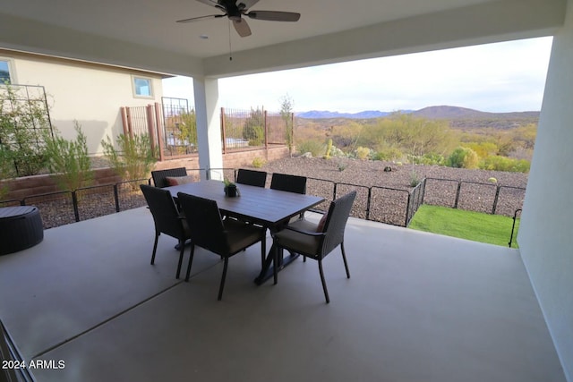 view of patio / terrace featuring a mountain view and ceiling fan