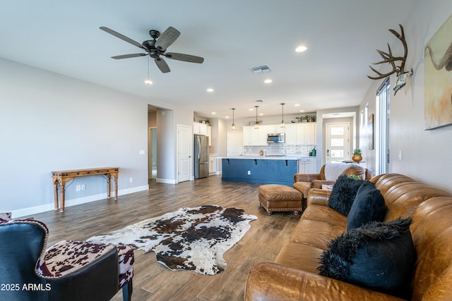 living room featuring hardwood / wood-style flooring and ceiling fan