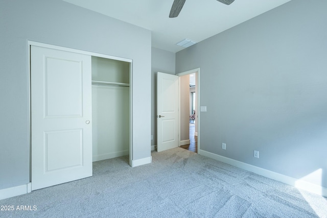 unfurnished bedroom with ceiling fan, a closet, and carpet floors