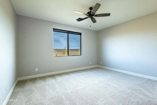 empty room featuring carpet flooring and ceiling fan