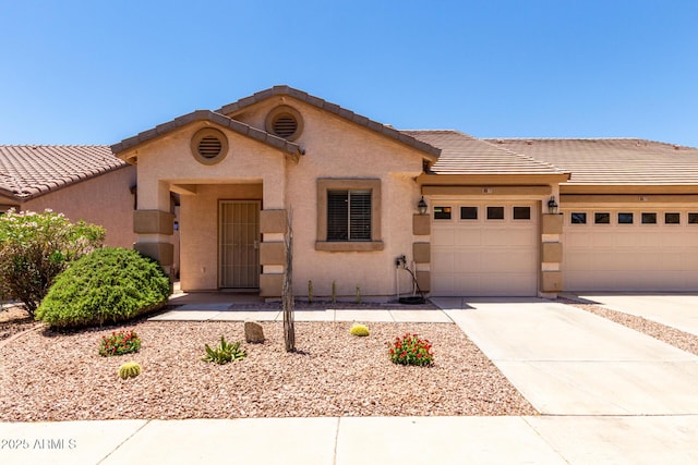 2250 E Deer Valley Rd Unit 96, Phoenix, AZ 85024 - mediterranean / spanish home featuring an attached garage, concrete driveway, a tile roof, and stucco siding