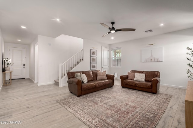 living room featuring light hardwood / wood-style flooring and ceiling fan