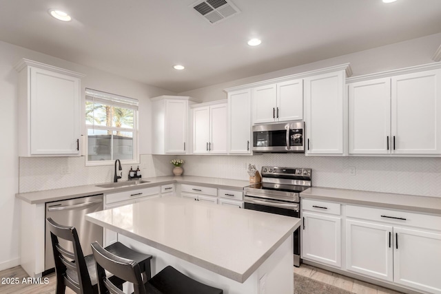 kitchen featuring white cabinetry, sink, and stainless steel appliances