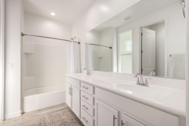 bathroom featuring vanity, hardwood / wood-style floors, and shower / bath combo with shower curtain