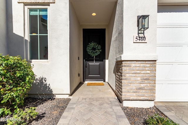 view of exterior entry with a garage