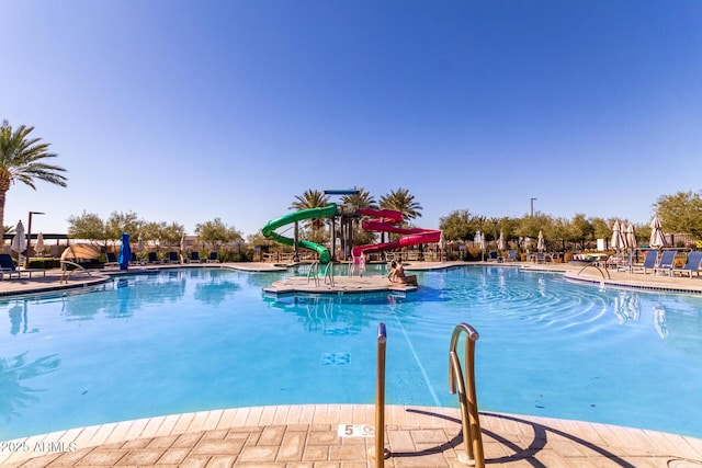 view of pool with a patio and a water slide