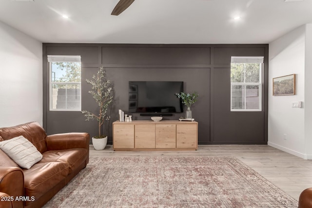 living room featuring ceiling fan and light wood-type flooring