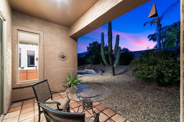 view of patio terrace at dusk