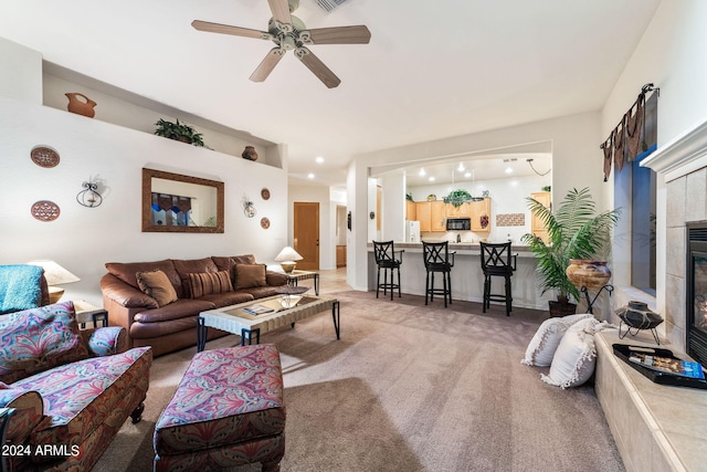 living room with ceiling fan, a fireplace, and carpet