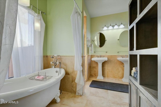 bathroom with tile patterned floors, a bathing tub, and tile walls