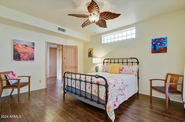 bedroom with ceiling fan and dark wood-type flooring