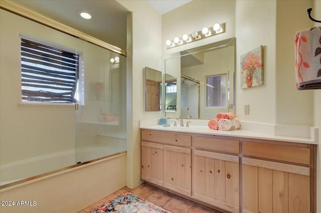 bathroom featuring tile patterned floors, vanity, and bath / shower combo with glass door